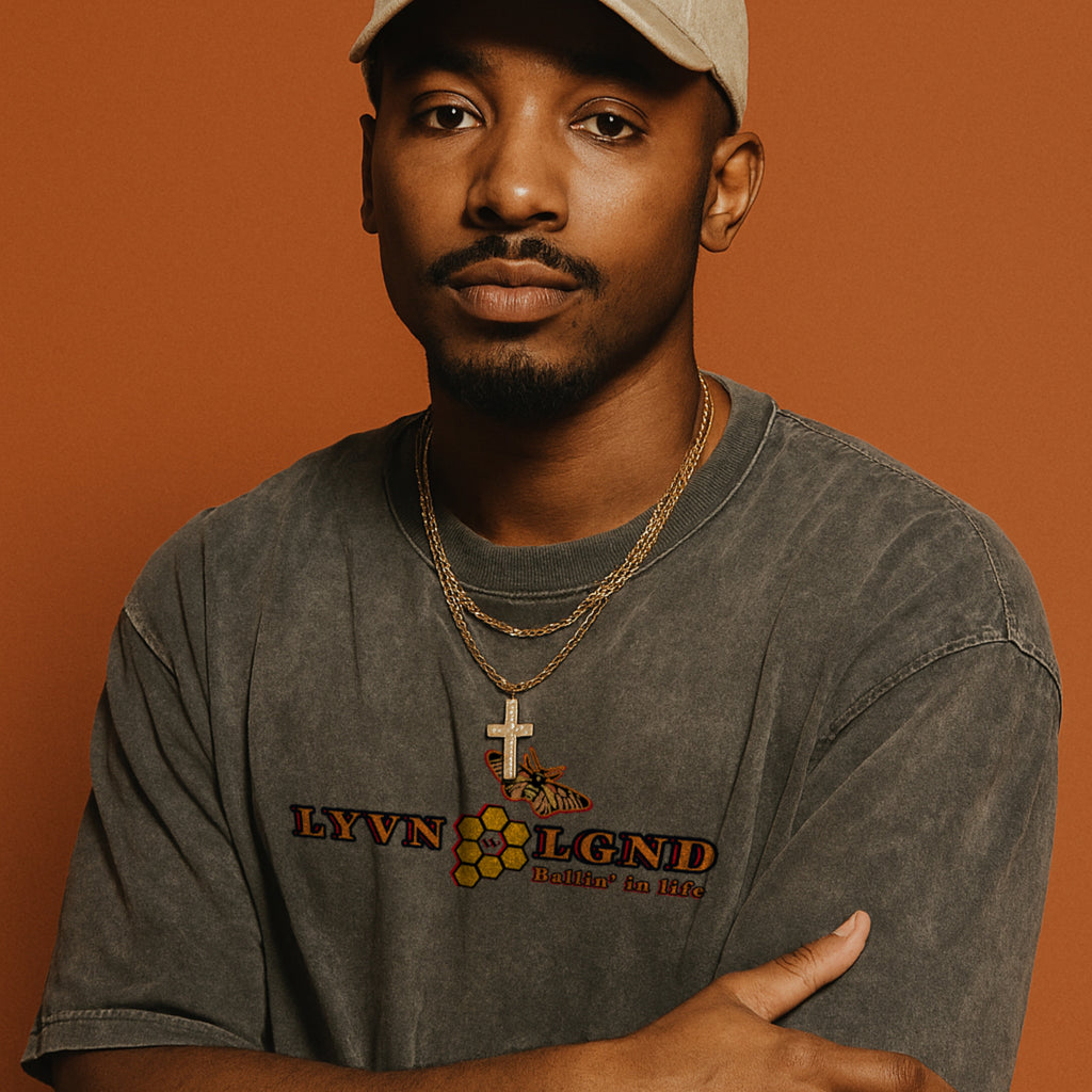 Man wearing a gray t-shirt with a logo and text on an orange background